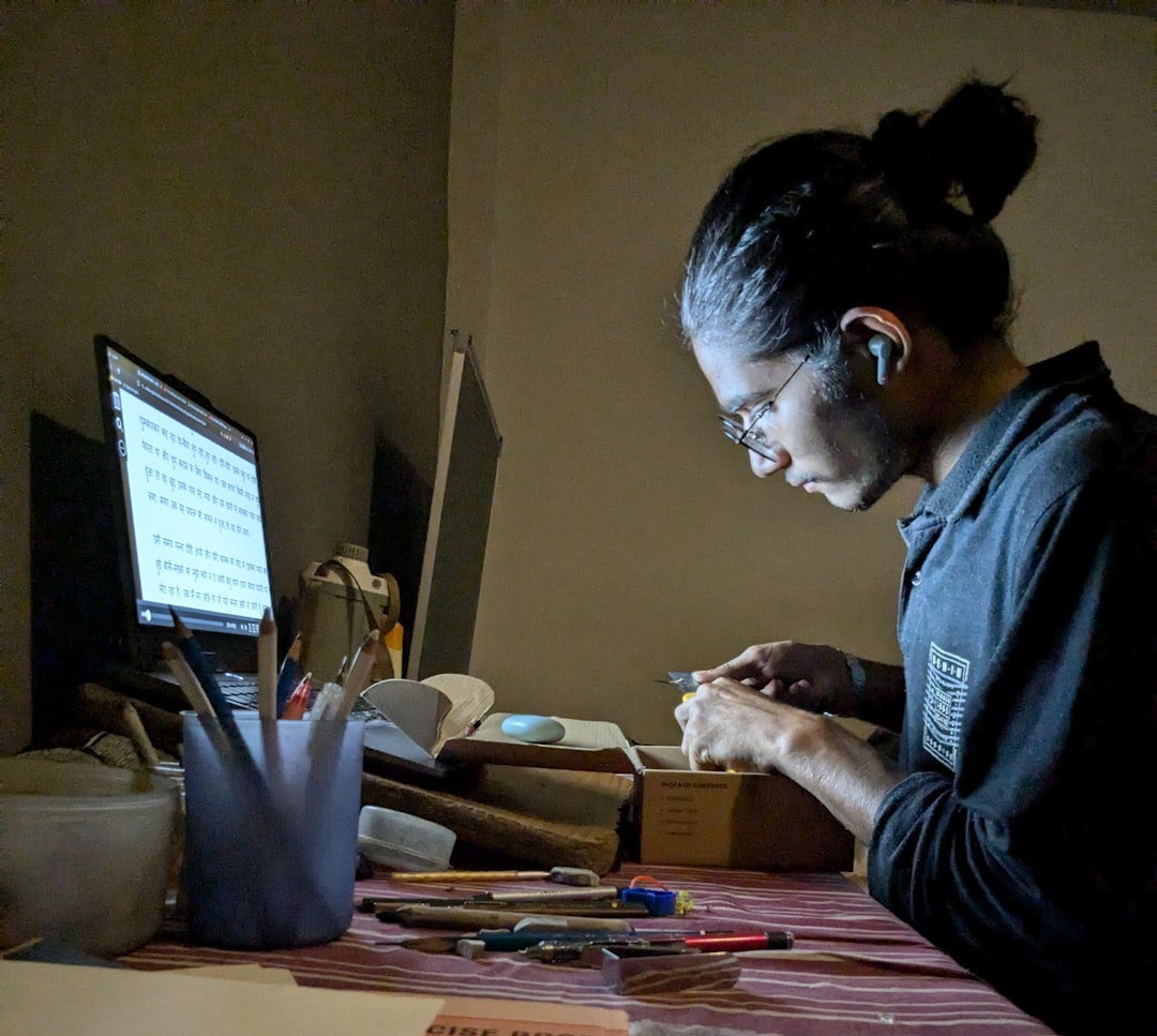A woman sitting at a desk working on a computer